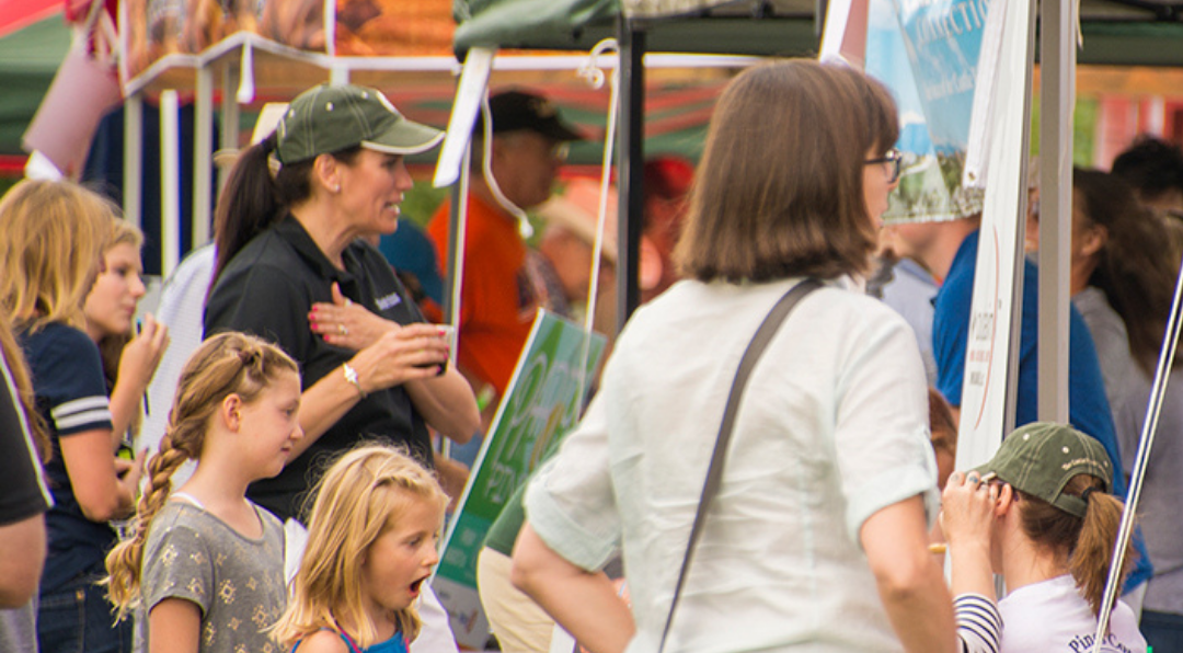 Residents explore vendor booths at Party in the Park.