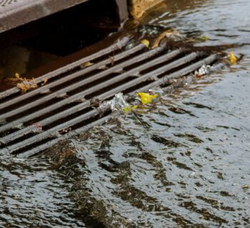 Water gushing from storm sewer following very heavy rainfall