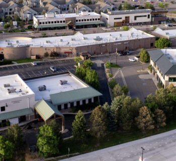 Commercial district in Castle Pines with cars driving on Monarch Boulevard.