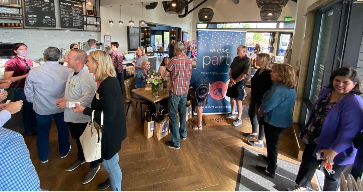 Group of adults gathering inside a coffee shop.