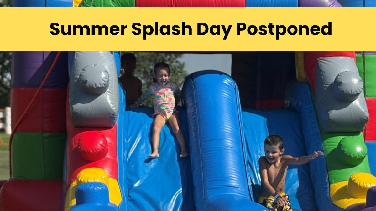 Two children sliding down a large colorful water slide.